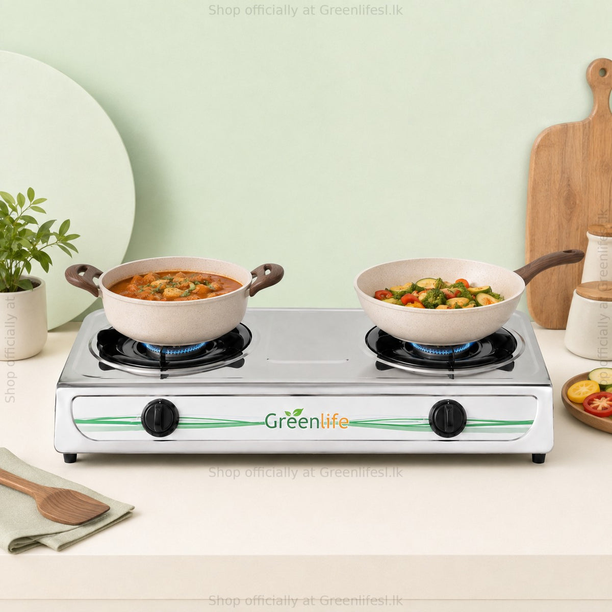Green Life 2-burner stainless steel gas cooker cooking curry and vegetables in a home kitchen