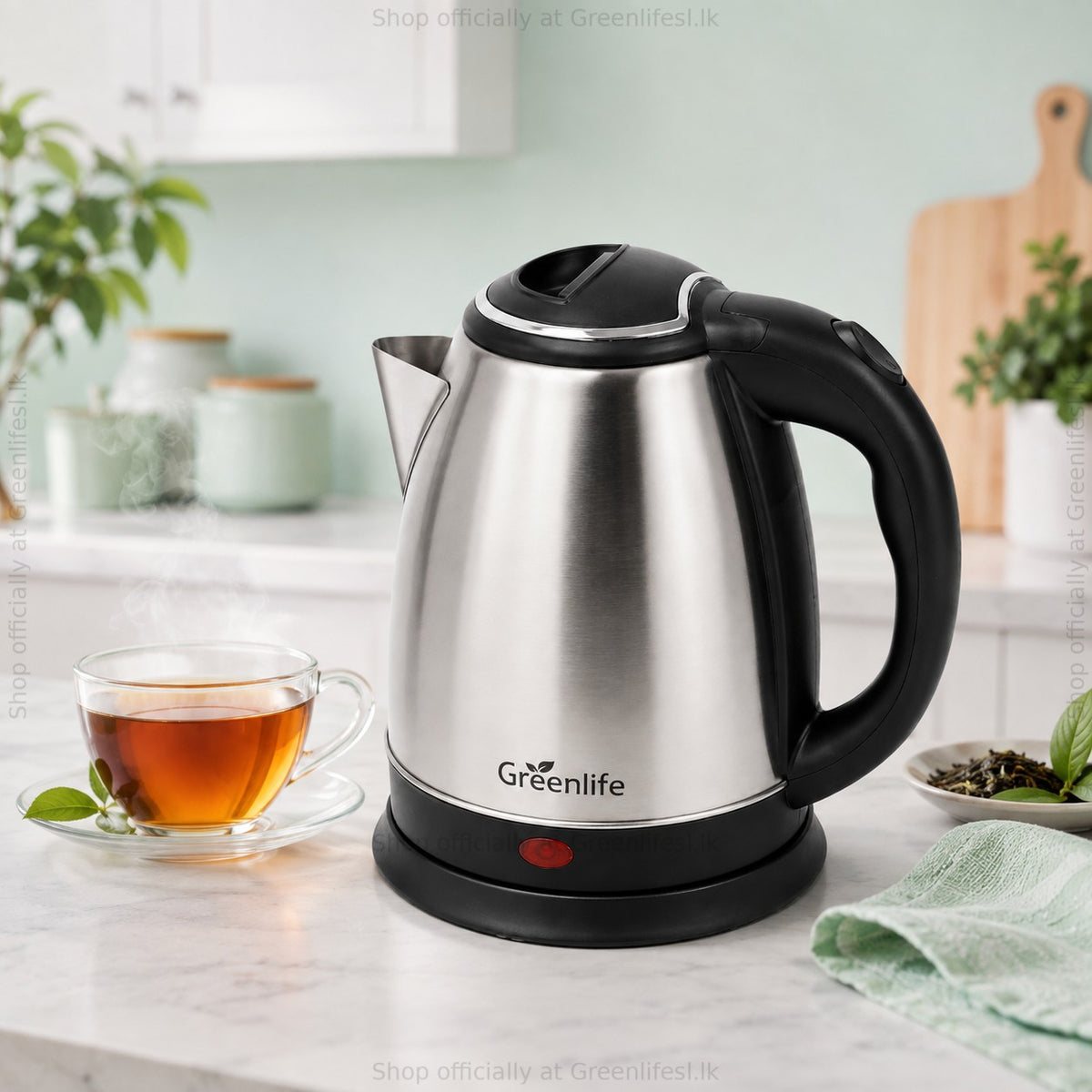 Green Life 1.8L stainless steel electric kettle on a kitchen counter with a cup of tea