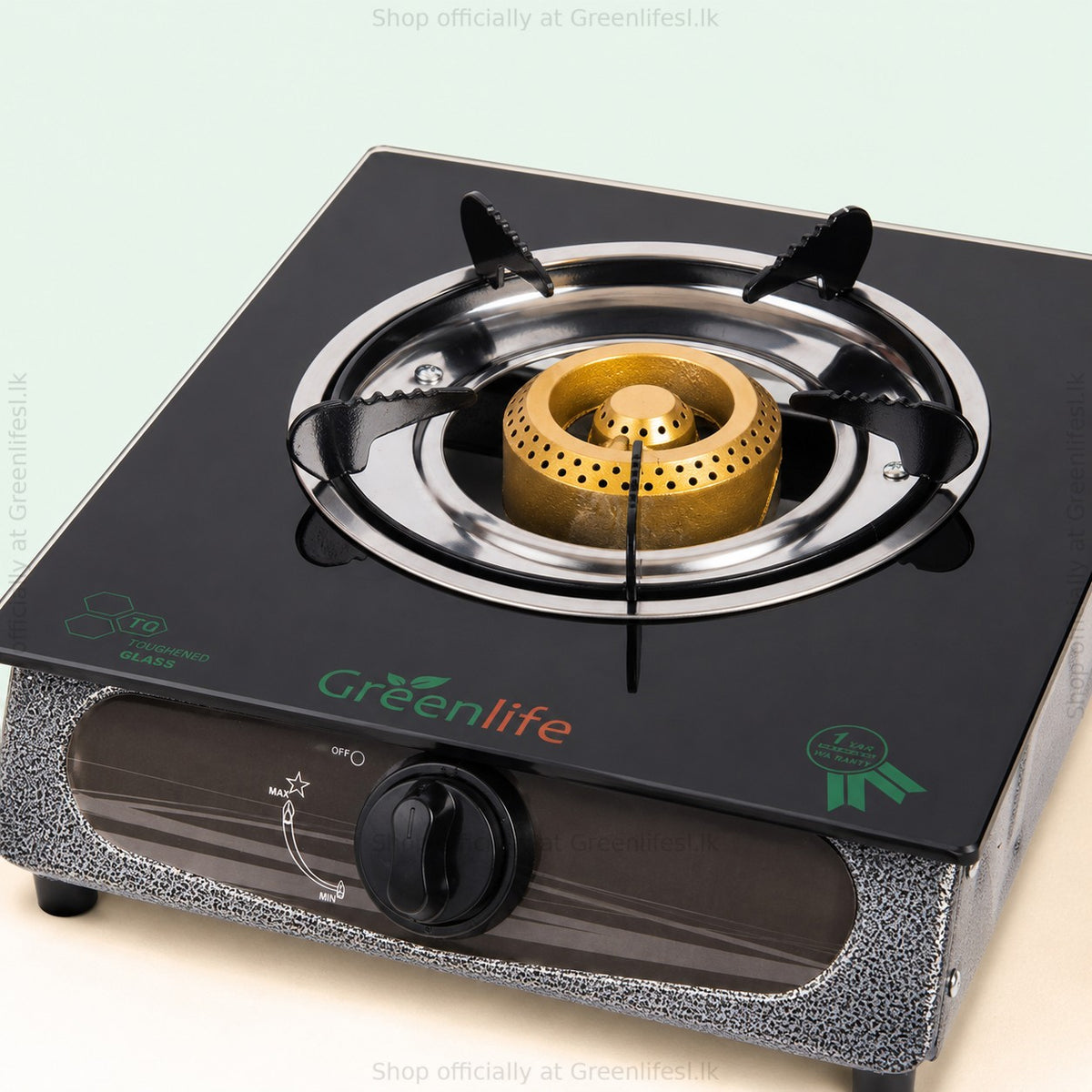 Close-up of the Green Life single burner glass top gas stove brass burner and black glass top
