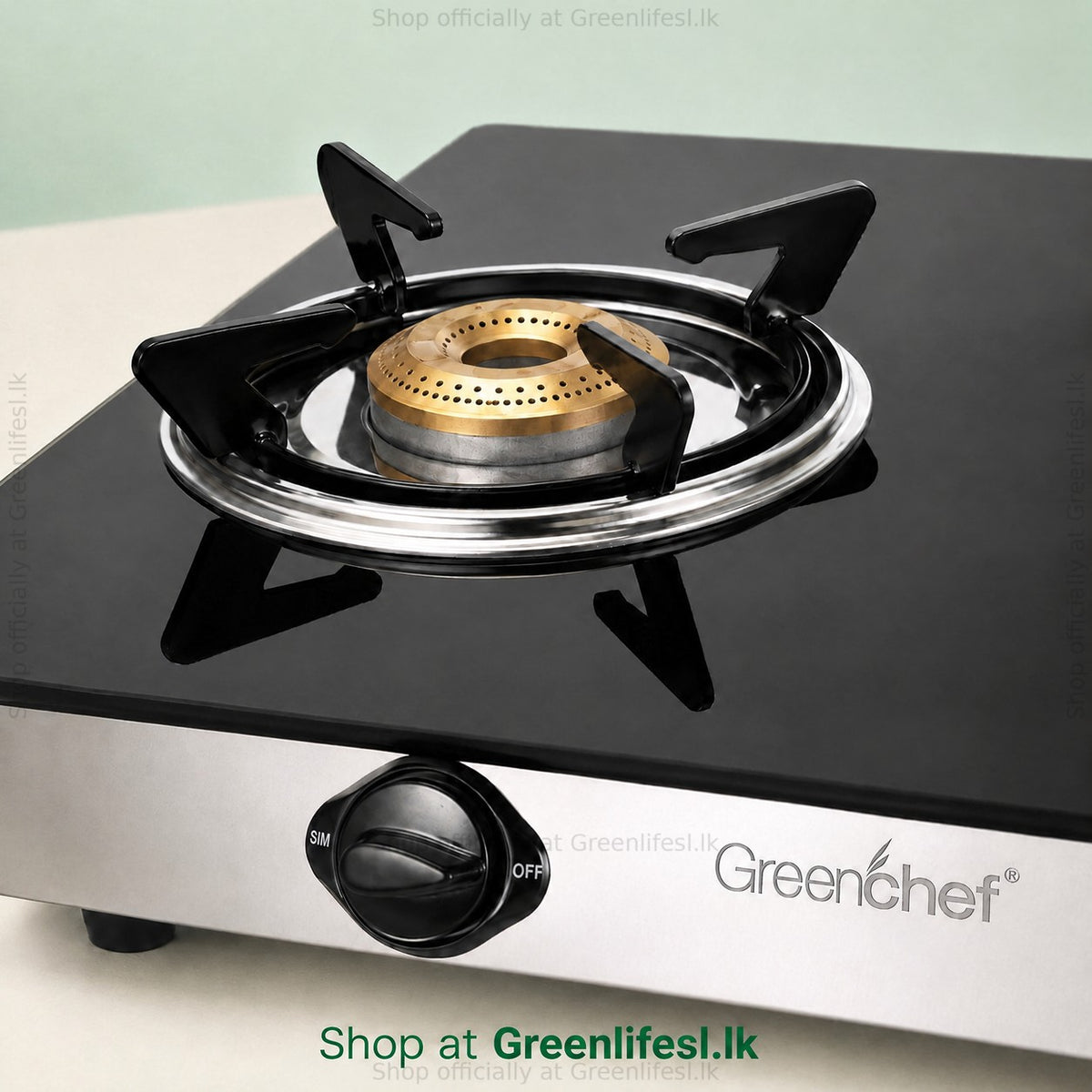 Close-up of a brass burner and pan support on the GreenChef Elite 3-burner glass top gas stove