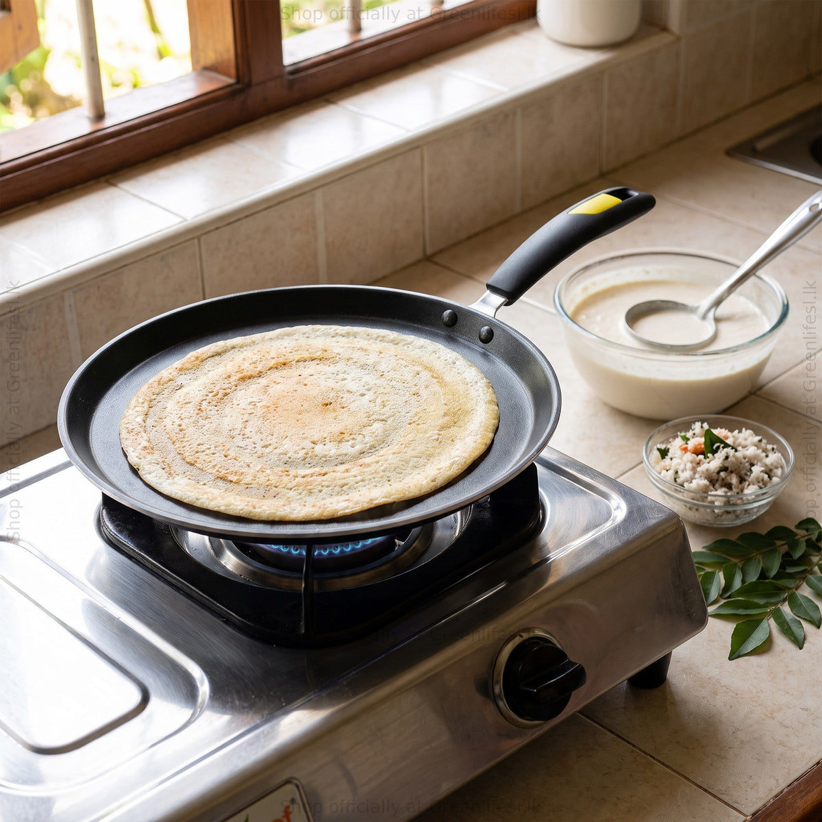 GreenChef Evok non-stick flat tawa cooking a dosa on a gas stove beside batter and chutney