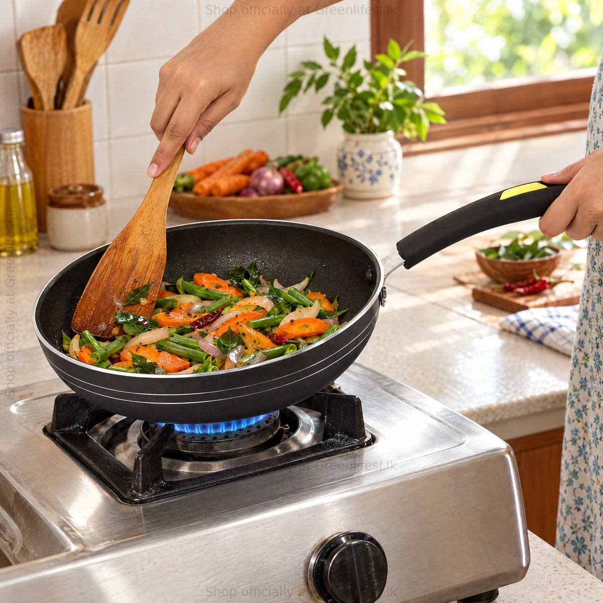 GreenChef Evok 240mm non-stick fry pan stir-frying vegetables on a gas stove in a home kitchen