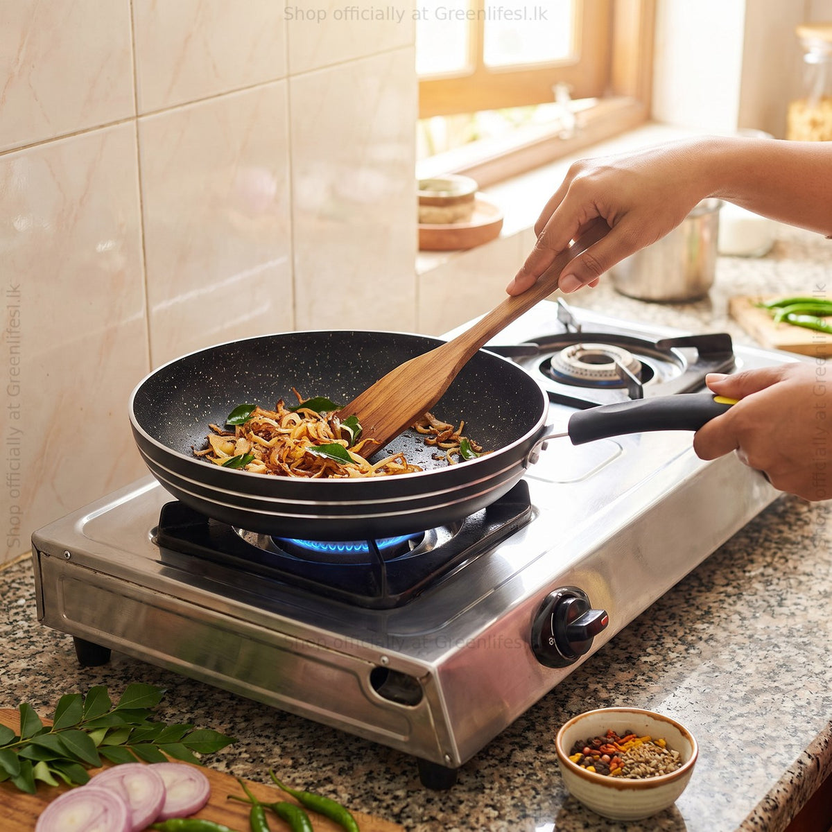 GreenChef Evok 280mm non-stick fry pan frying onions on a gas stove in a home kitchen
