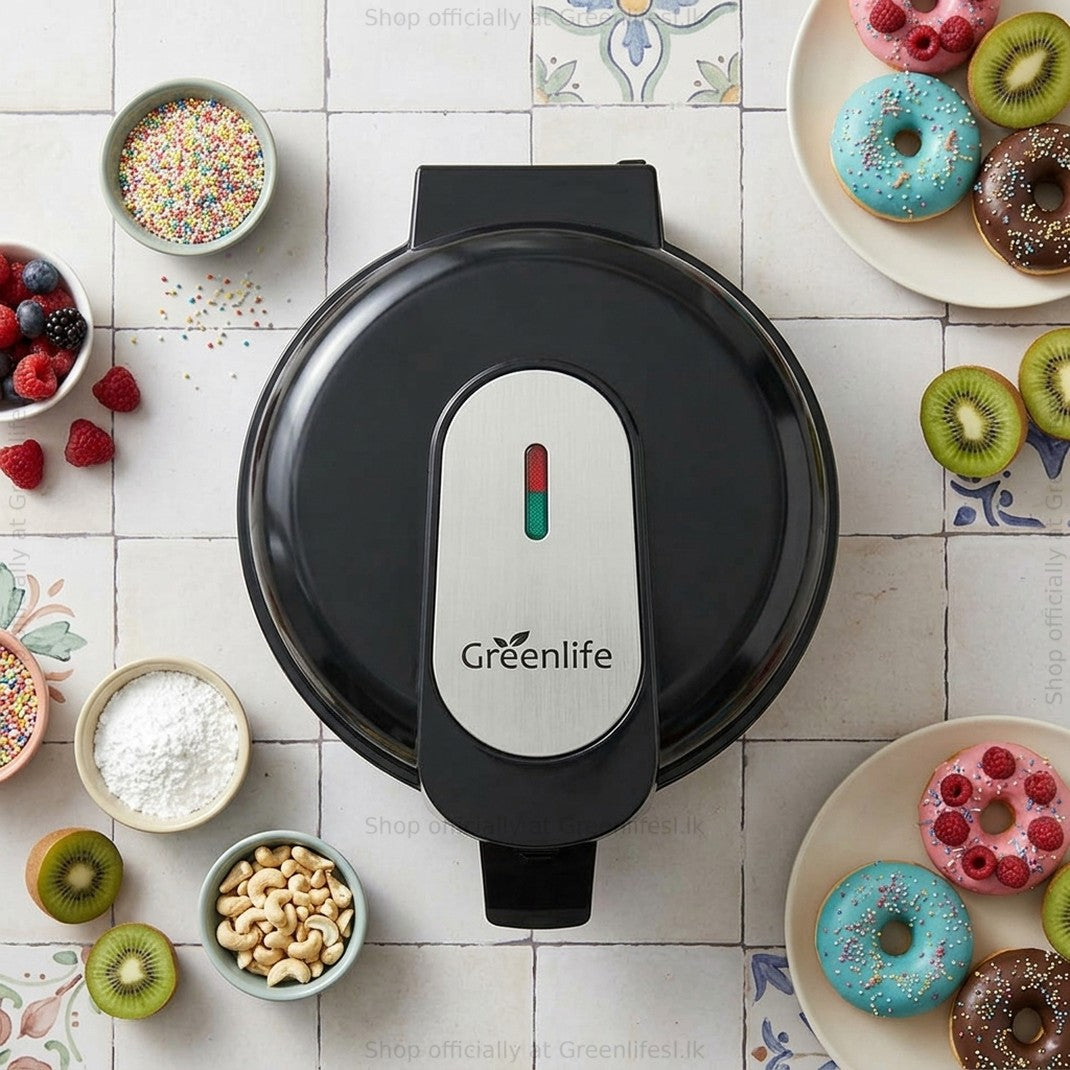 Greenlife electric doughnut maker 750W on a tiled table with decorated doughnuts, fruit and sprinkles