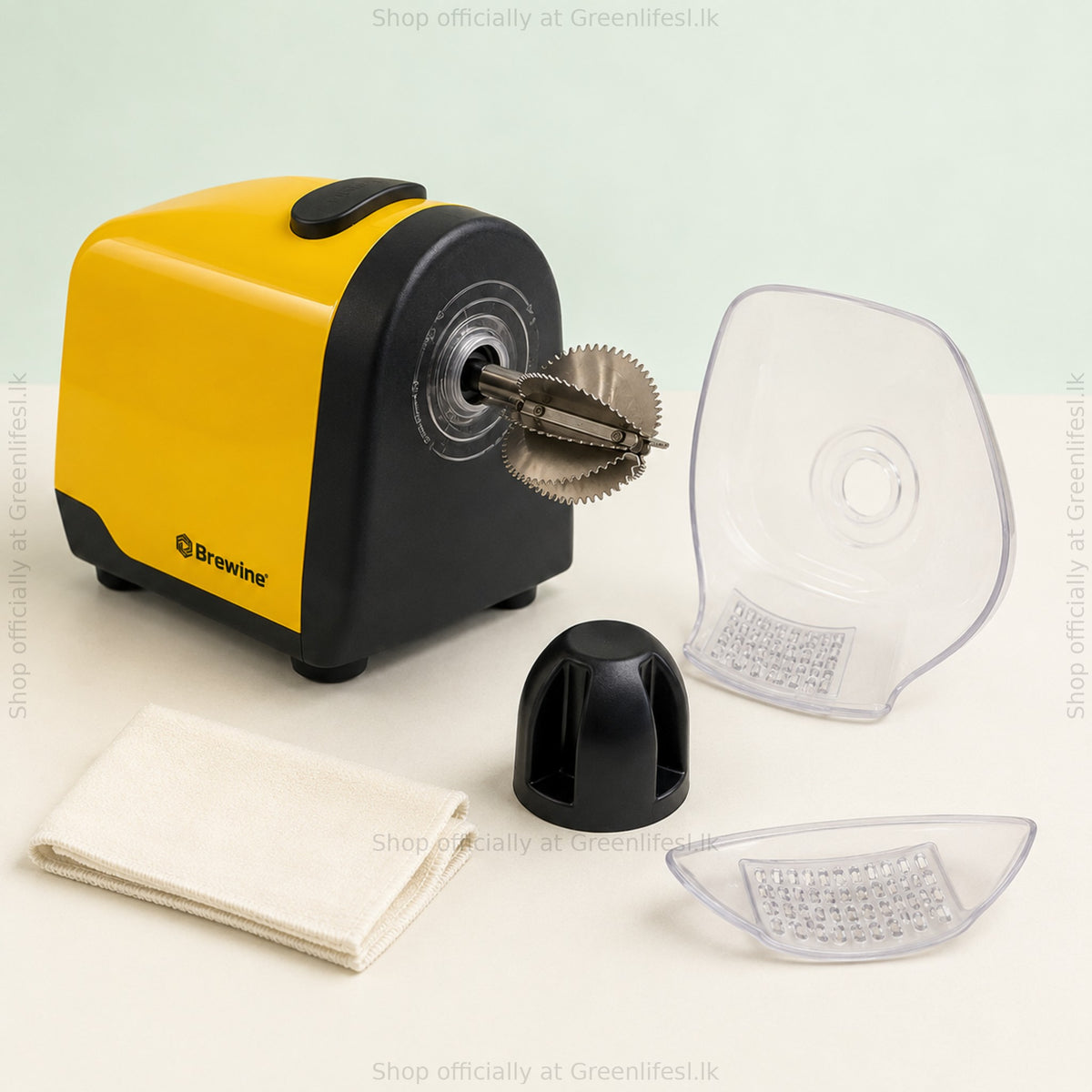 Brewine 2-in-1 coconut scraper and citrus press with splash cover, citrus cone and tray removed beside a cloth