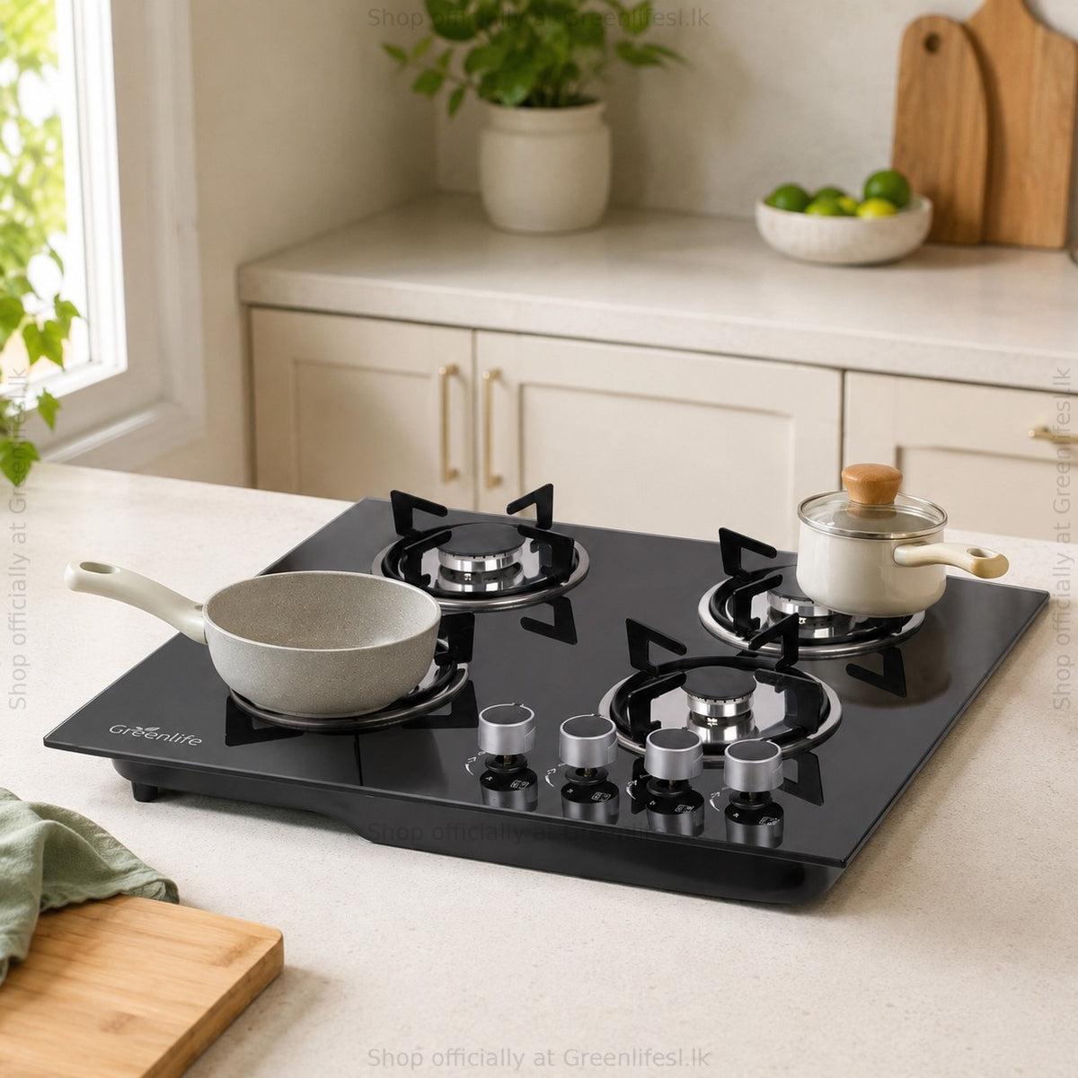 Green Life 4-burner tempered glass gas hob with a frying pan and saucepan in a bright kitchen