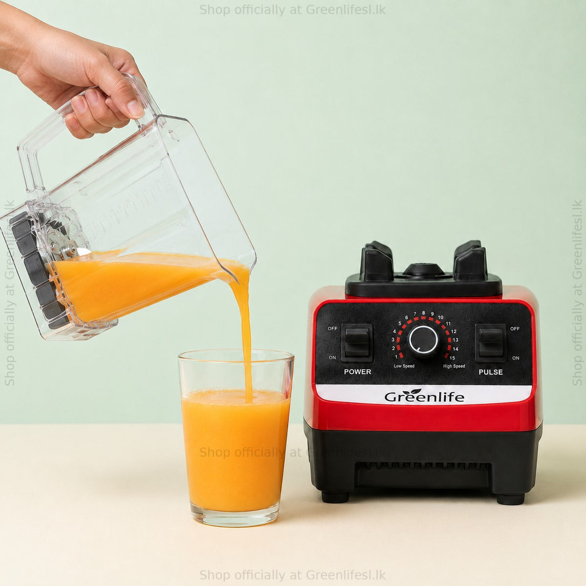 Pouring fresh orange juice from the Green Life electric juicer blender 300W jar