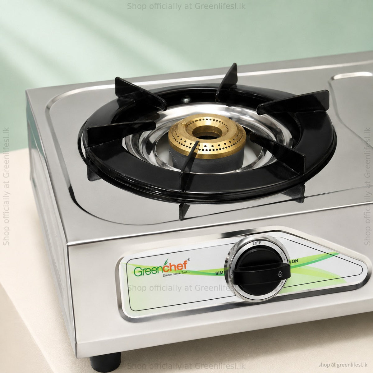 Close-up of a brass burner, pan support and knob on the GreenChef Chandini 2-burner auto ignition gas stove