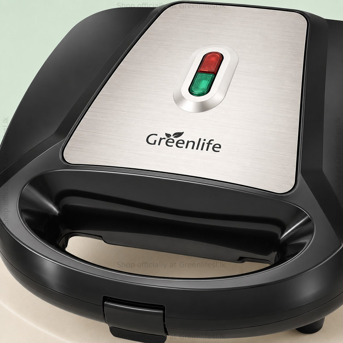 Close-up of the Greenlife 7-in-1 sandwich, waffle and donut maker lid, logo and indicator lights
